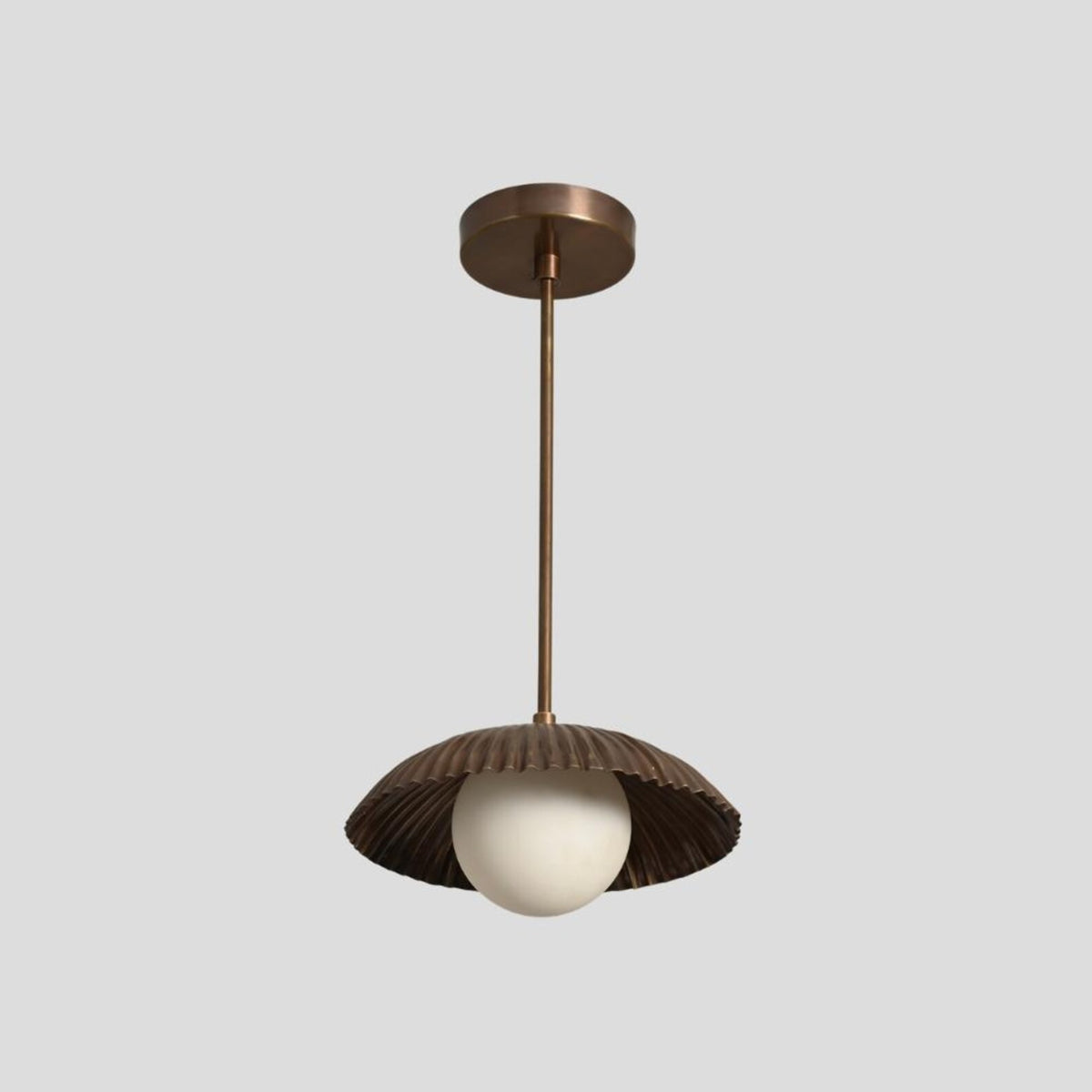 Modern handmade brass ceiling light featuring ribbed dome shade and white glass globe, perfect for contemporary and minimalist spaces.