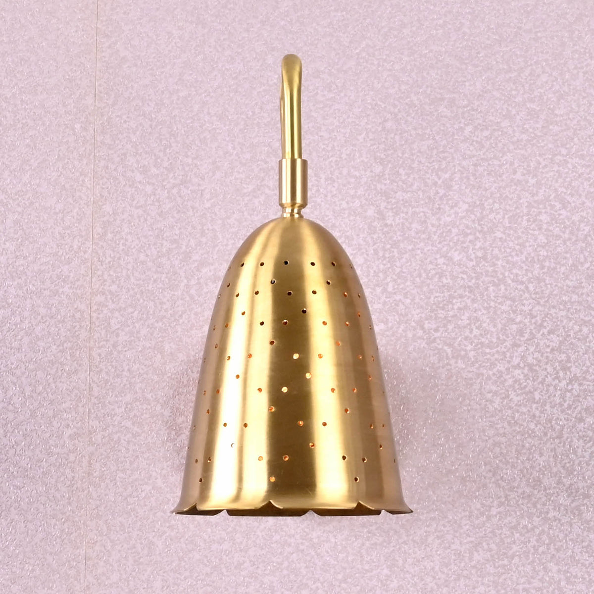 Handmade brass perforated bell-shaped wall sconce with scalloped edge shade