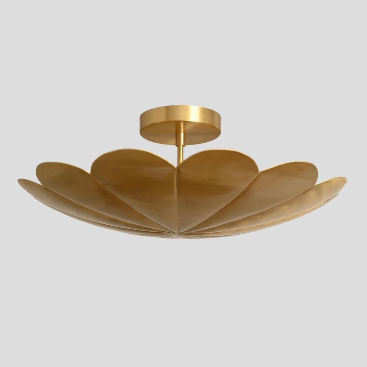 Close-up of brass petal chandelier – handmade ceiling light with floral petal silhouette and brushed brass finish