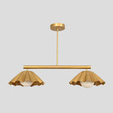 Brass chandelier with two ruffle-edged shades and globe lights, handcrafted pendant for dining rooms and boutique interiors.