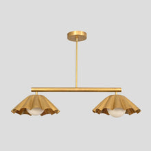 Brass chandelier with two ruffle-edged shades and globe lights, handcrafted pendant for dining rooms and boutique interiors.