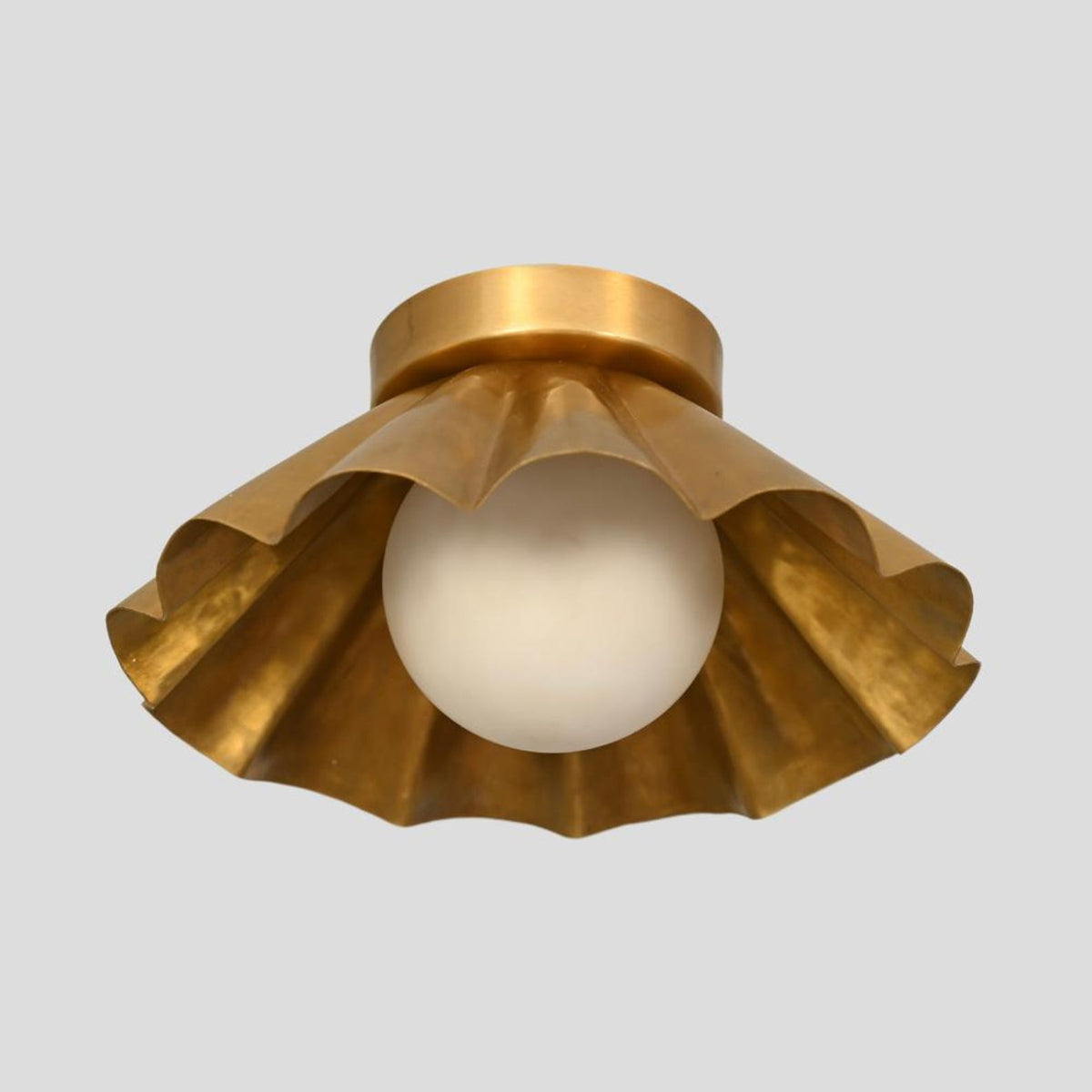 Brass fluted ceiling light with scalloped edge design and central globe bulb