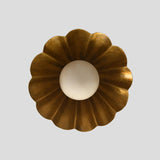 Overhead view of brass scalloped flush mount ceiling light with flower-like fluted design