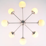 Bottom view of 8 light brass sputnik chandelier showing radial arms and evenly spaced globe shades