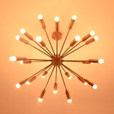 Bottom view of brass sputnik chandelier illuminated in dark setting with soft warm light.