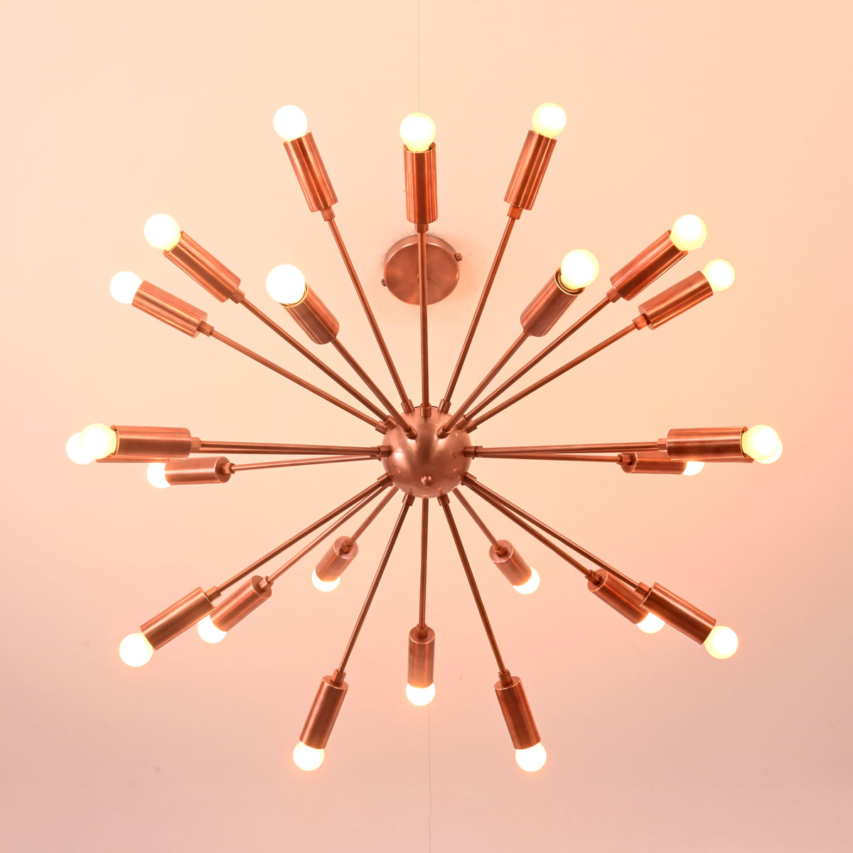 Bottom view of brass sputnik chandelier showing radial arm layout and balanced modern geometry.