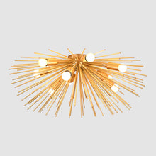 Illuminated chandelier radiating from the center with glowing brass rods and soft ceiling light