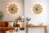 Mid-century brass starburst wall light showcased in modern interiors, highlighting its sculptural form and warm ambient glow.