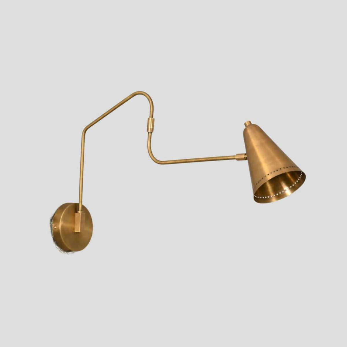 Brass swing arm wall lamp with cone shade, adjustable handcrafted minimalist lighting fixture angled view