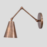 Vintage-inspired brass wall sconce with adjustable swing arm and round base