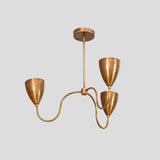 Diagonal view of handmade brass chandelier featuring three conical shades and sculptural curved arms in a brushed finish.