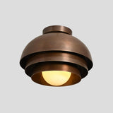 Angled view of modern brass flush mount chandelier – layered dome design with soft uplighting and solid brass construction