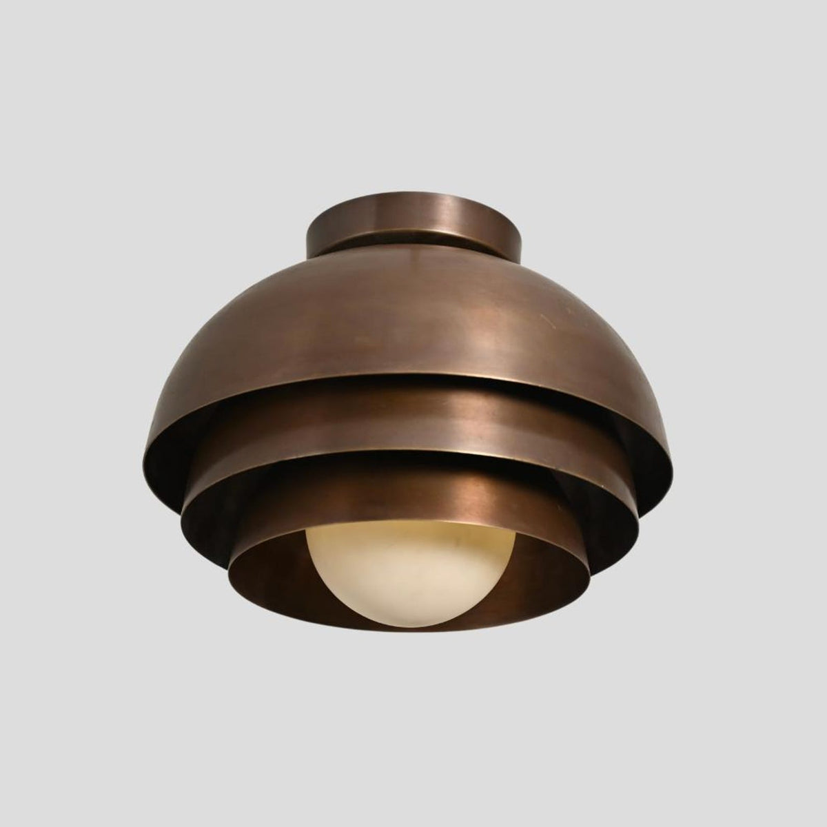 Close-up of tiered dome brass flush mount chandelier – handcrafted ceiling light with lacquer-coated brass finish