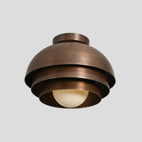 Close-up of tiered dome brass flush mount chandelier – handcrafted ceiling light with lacquer-coated brass finish