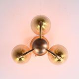 Top-down view of brass triple cup light showing circular geometry and refined brass detailing.