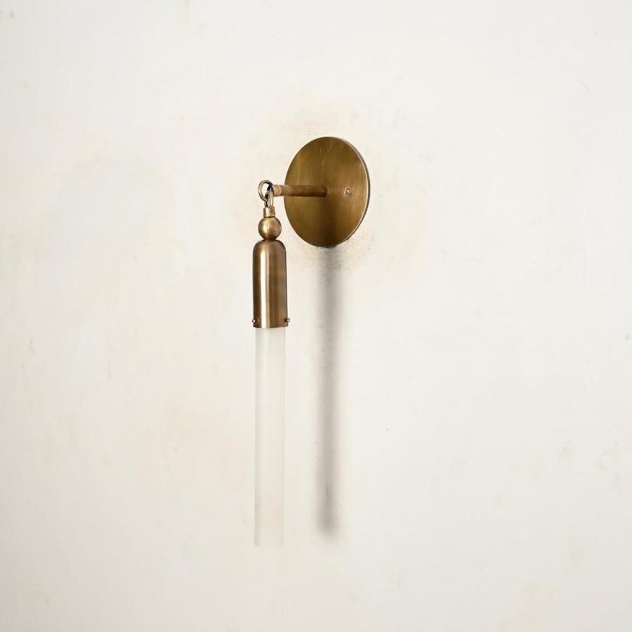 Handmade brass vertical wall sconce with slim glass tube shade, modern minimalist wall light front view