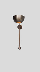 Full height view of brass wall sconce with round bowl shade and extended rod