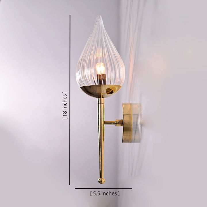 Brass wall sconce with teardrop fluted glass shade shown with height 18 inches and width 5.5 inches