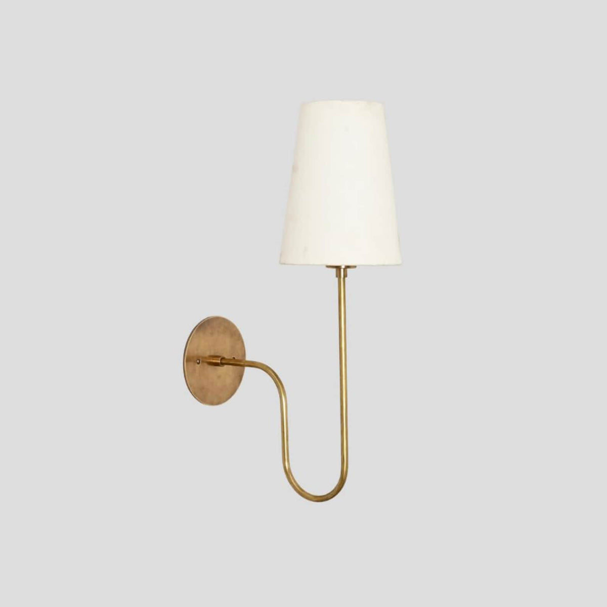 Customizable handmade brass wall sconce with fabric shade and lacquer-coated finish, blending modern simplicity with timeless style.