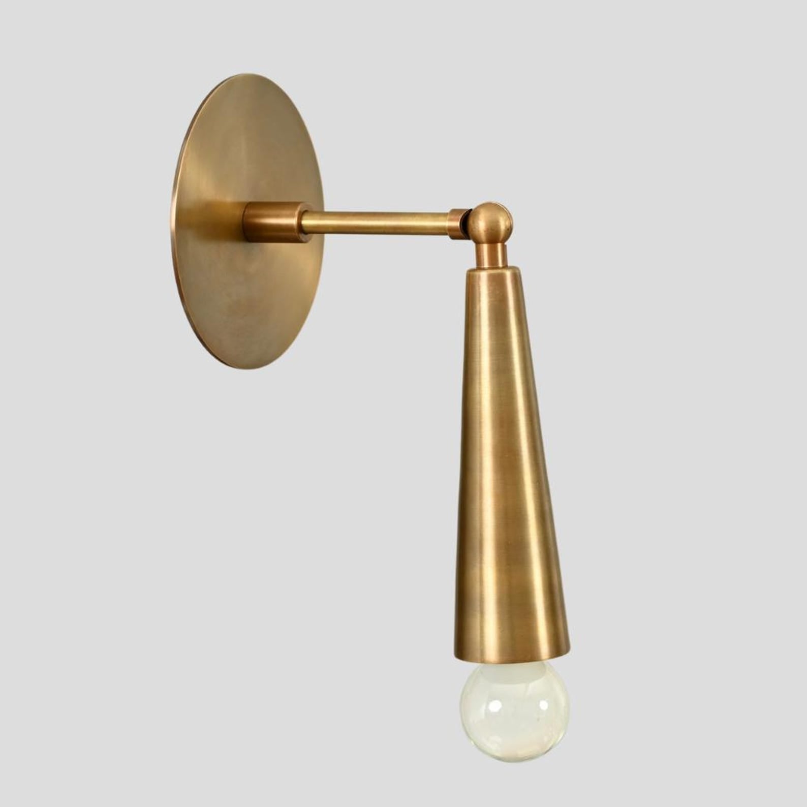 Industrial style brass wall sconce with exposed bulb, handcrafted cone-shaped minimalist design by Brass Leaf Studio.