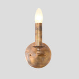 Front view of handmade brass candle style wall sconce with industrial vintage finish – Brass Leaf Studio
