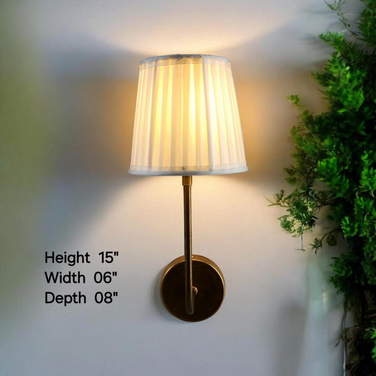 Brass wall sconce showing height 15 inches, width 6 inches, depth 8 inches with glowing pleated shade.