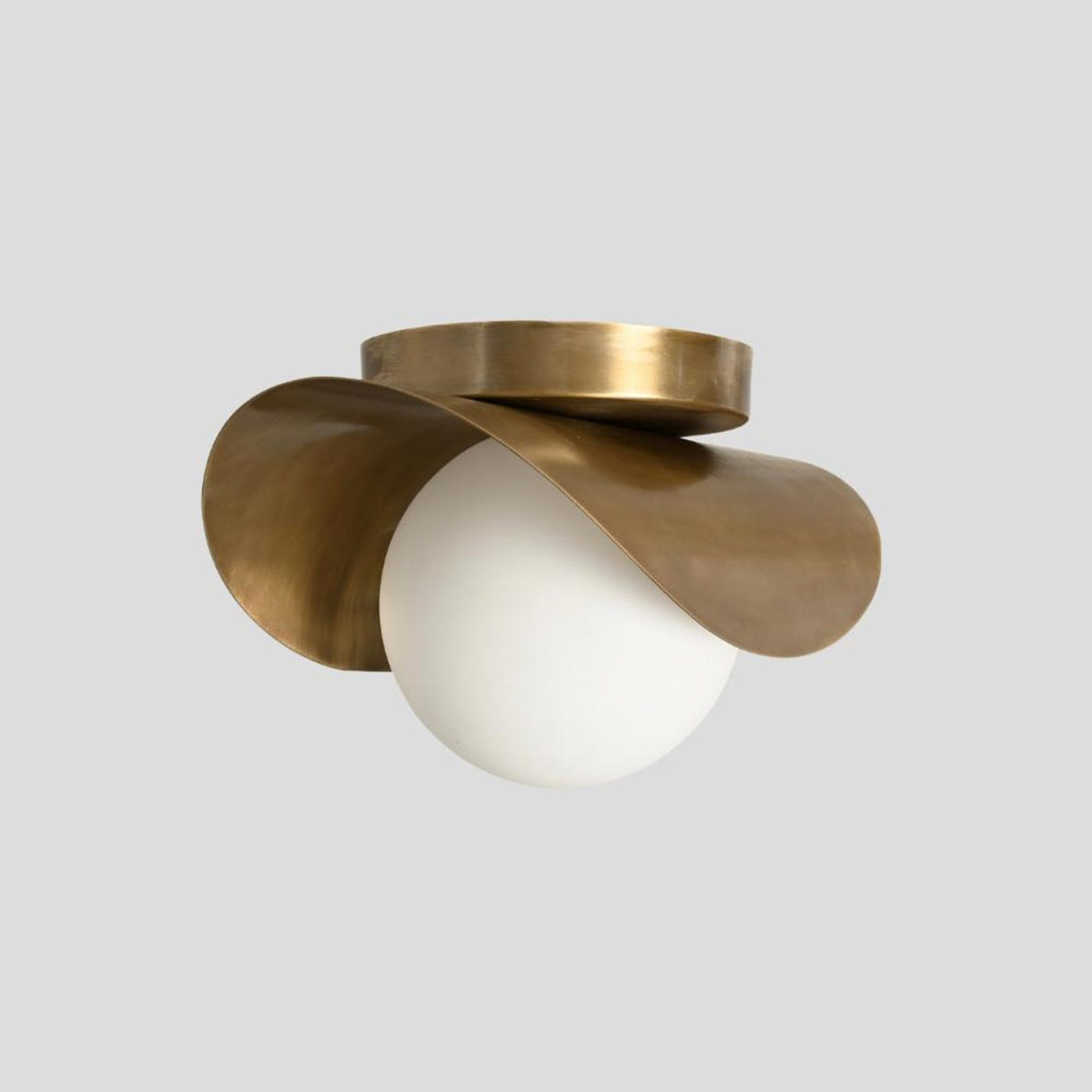 Handmade sculptural brass flush mount ceiling light with artistic wave design and opal glass globe