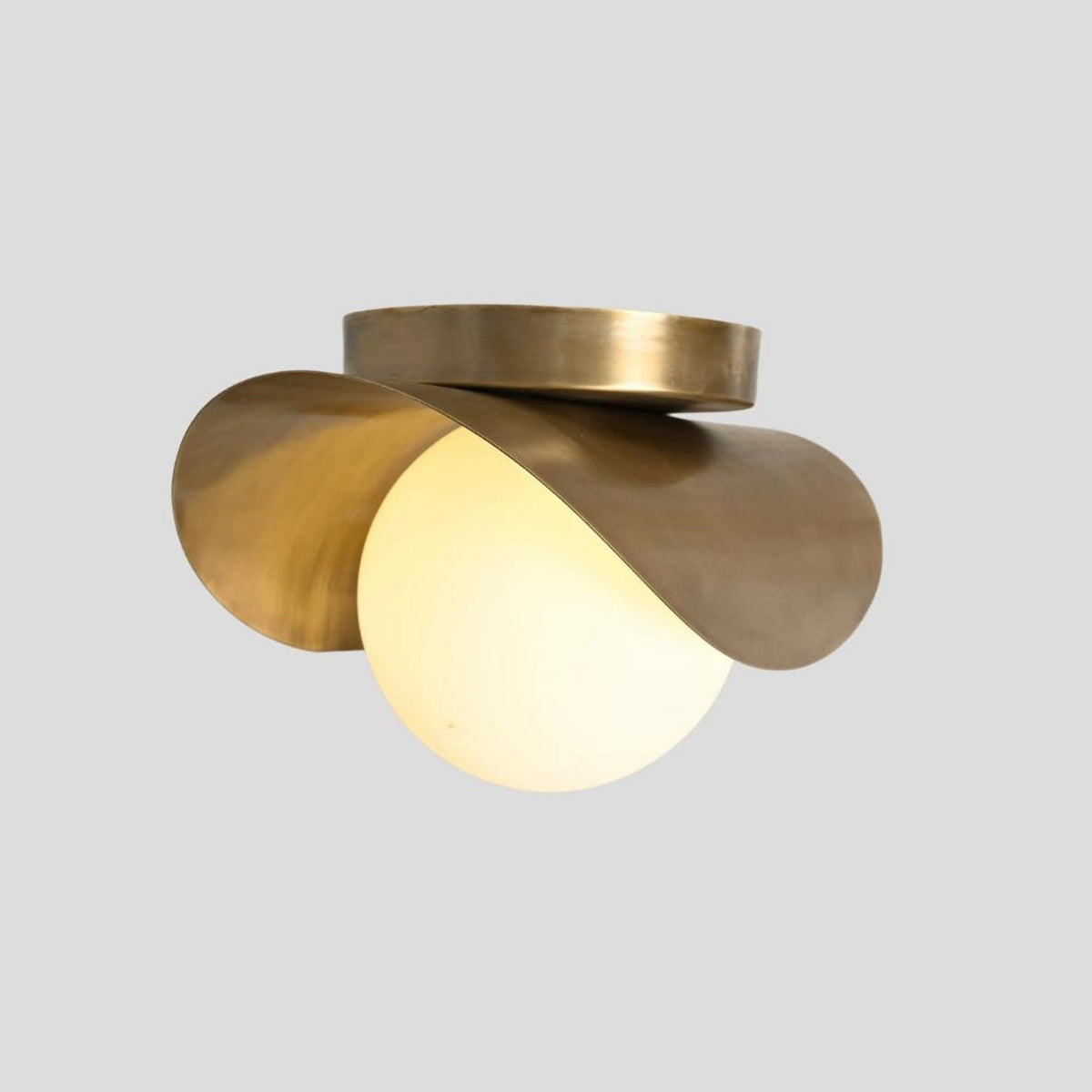 Brass wave flush mount light with glowing opal glass globe – modern handmade ceiling fixture