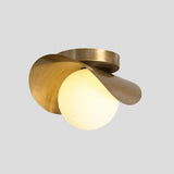 Handcrafted brass wave ceiling light with smooth opal globe – elegant sculptural flush mount design