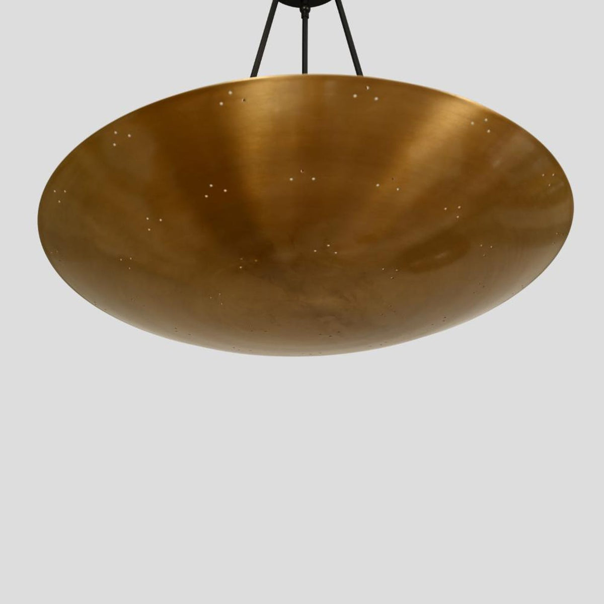 Bottom view of large brass dome chandelier – handmade pendant light with starry perforations and warm glowing finish
