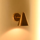 Adjustable solid brass wall lamp with cone shade, round canopy and compact architectural profile