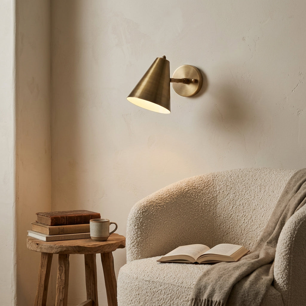 Side view of Bruges brass patina wall sconce showing compact arm and cone-shaped shade