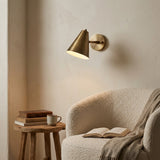Side view of Bruges brass patina wall sconce showing compact arm and cone-shaped shade