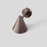 Top view of brushed antique brass wall sconce featuring elegant cone shape and artisanal brass detailing.