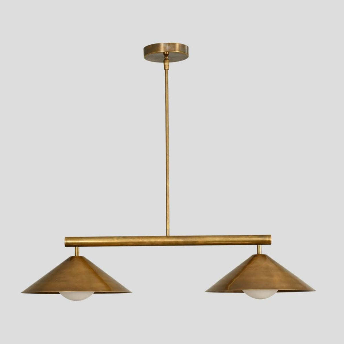 Brushed brass 2-light chandelier with twin cone shades, industrial-modern pendant lighting for cafes, dining rooms, and hotels.