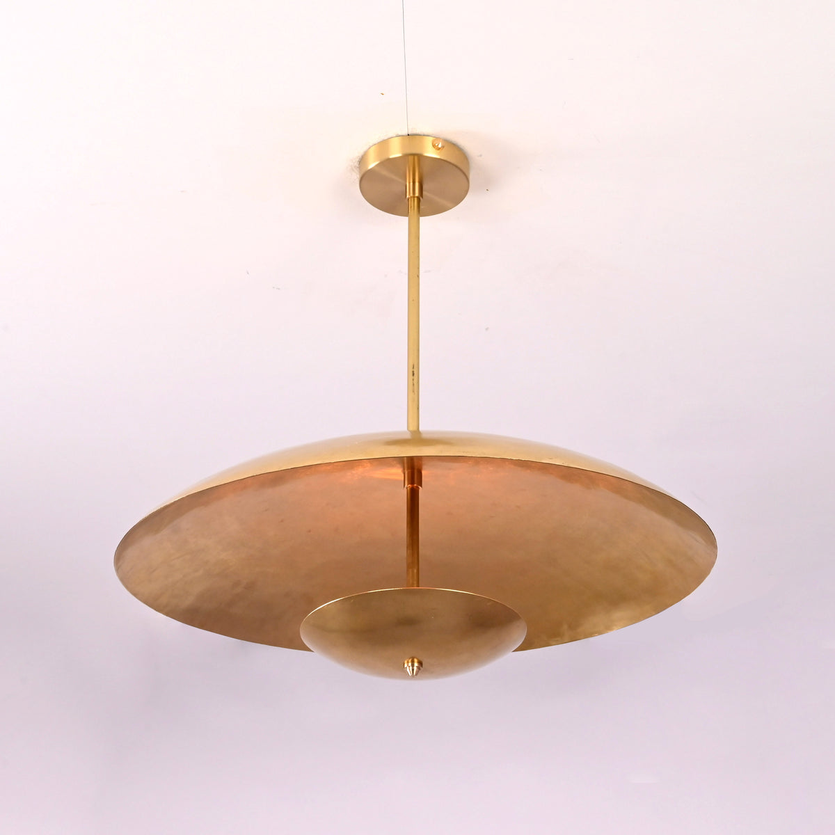 Angled view of brushed brass 3 light pendant chandelier showcasing layered disc structure.