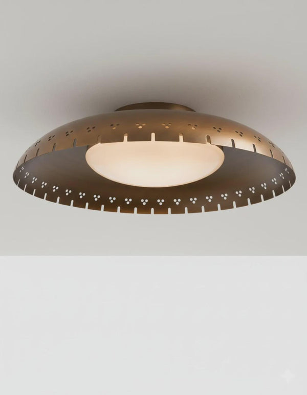 Brushed brass bowl flush mount ceiling light with disc glass globe providing warm ambient lighting in a modern interior
