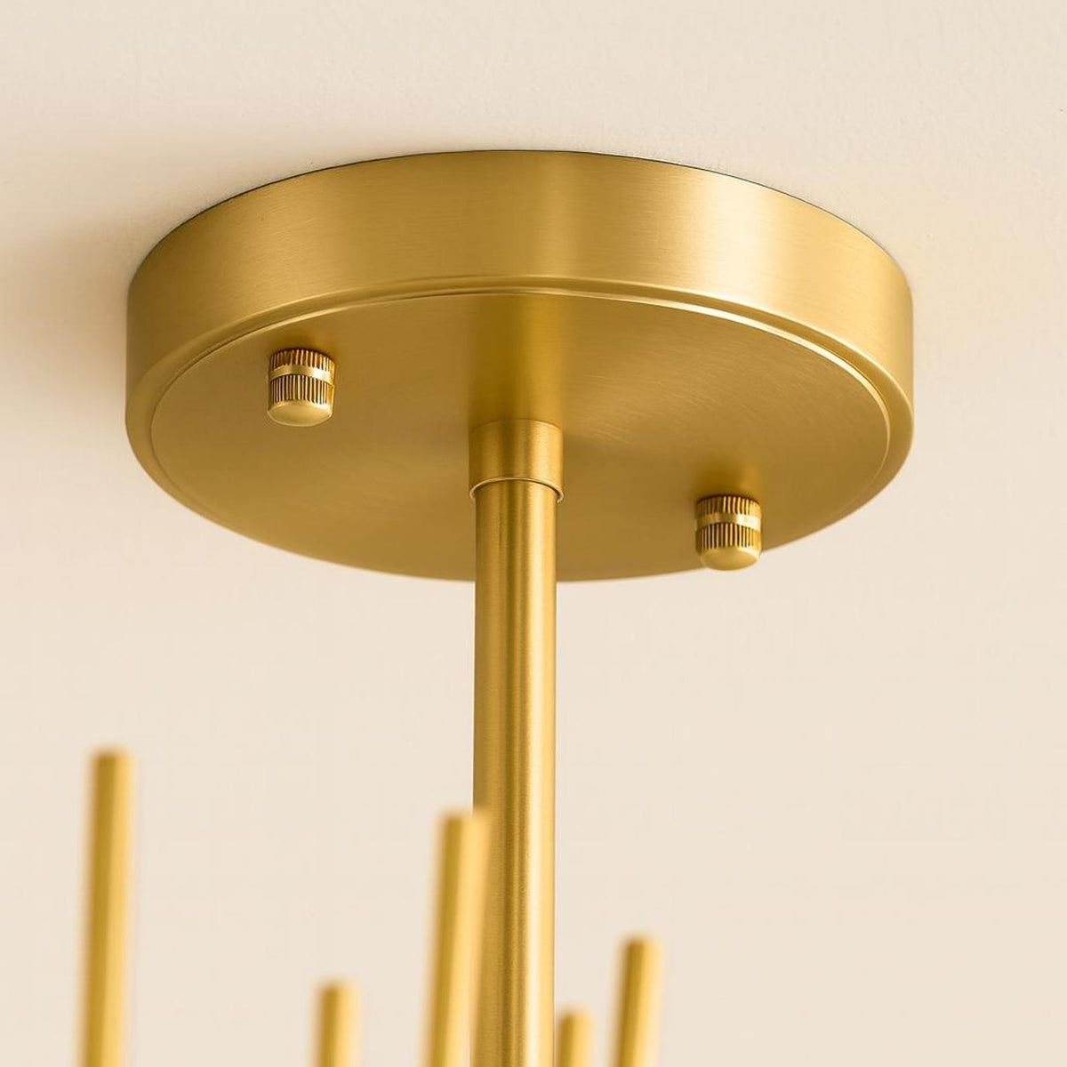 Close up of brushed brass ceiling canopy and suspension rod showing smooth lacquered finish and premium handcrafted brass construction.