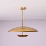 Front view of brushed brass disc pendant light with layered bowl shades and minimalist profile.