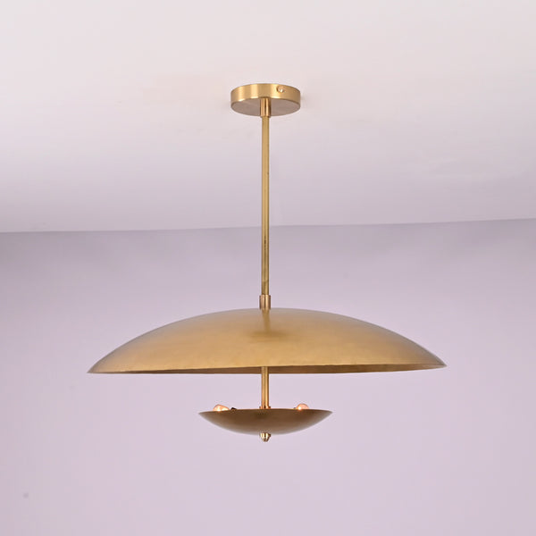 Front view of brushed brass disc pendant light with layered bowl shades and minimalist profile.