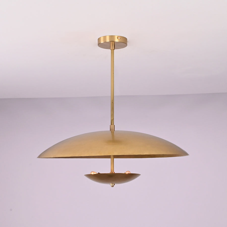 Front view of brushed brass disc pendant light with layered bowl shades and minimalist profile.