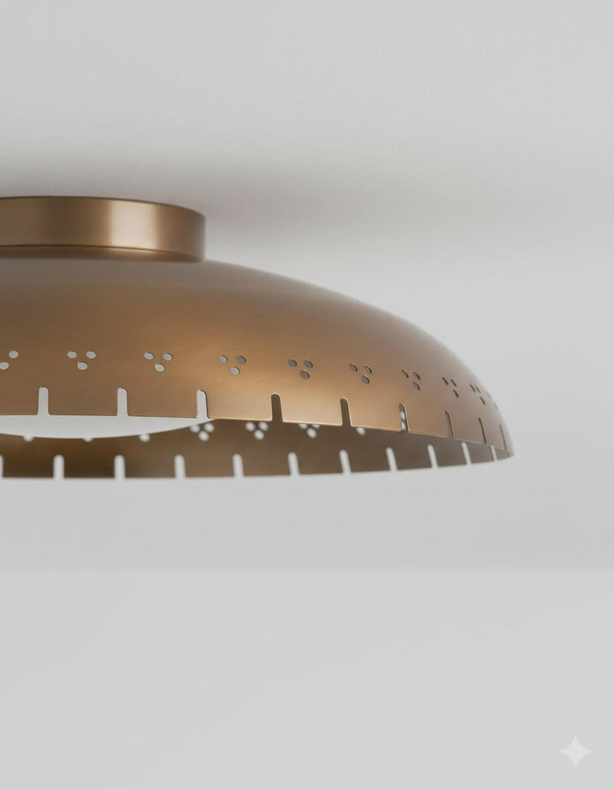 Close-up of brushed brass flush mount ceiling light showing perforated detailing and refined handcrafted finish