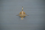 Front-on view of brushed brass gooseneck sconce mounted on wall, showing symmetrical design and elegant craftsmanship.