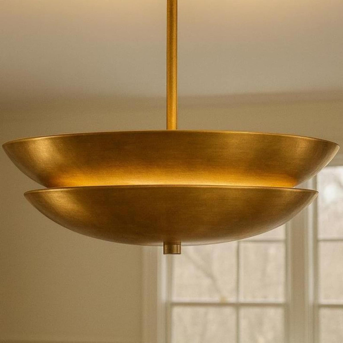 Solid brass layered bowl chandelier in mid-century modern style with warm ambient illumination