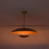 Detail view of brushed brass pendant ceiling canopy and solid brass drop rod connection.