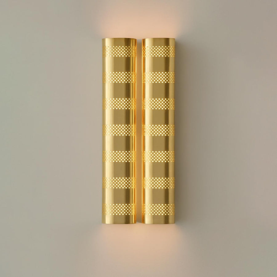 Brushed brass perforated wall sconce with warm ambient glow, modern industrial brass wall light by Brass Leaf Studio