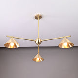 Three-arm brushed brass chandelier featuring sculpted cone shades and a minimalist industrial design.