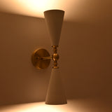 White enamel cone wall sconce with brushed brass arm, round canopy, and central sphere detail
