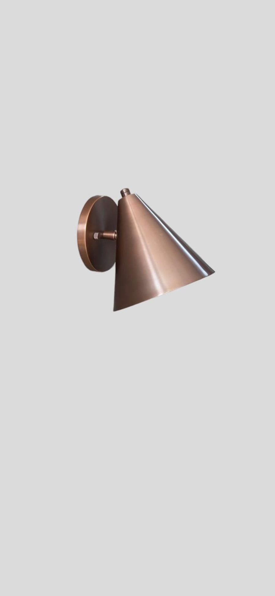 Handcrafted brushed copper cone wall light with minimalist design and warm metallic finish by Brass Leaf Studio.