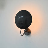 Brussels blackened brass wall sconce styled as elegant bedside lighting in a modern bedroom